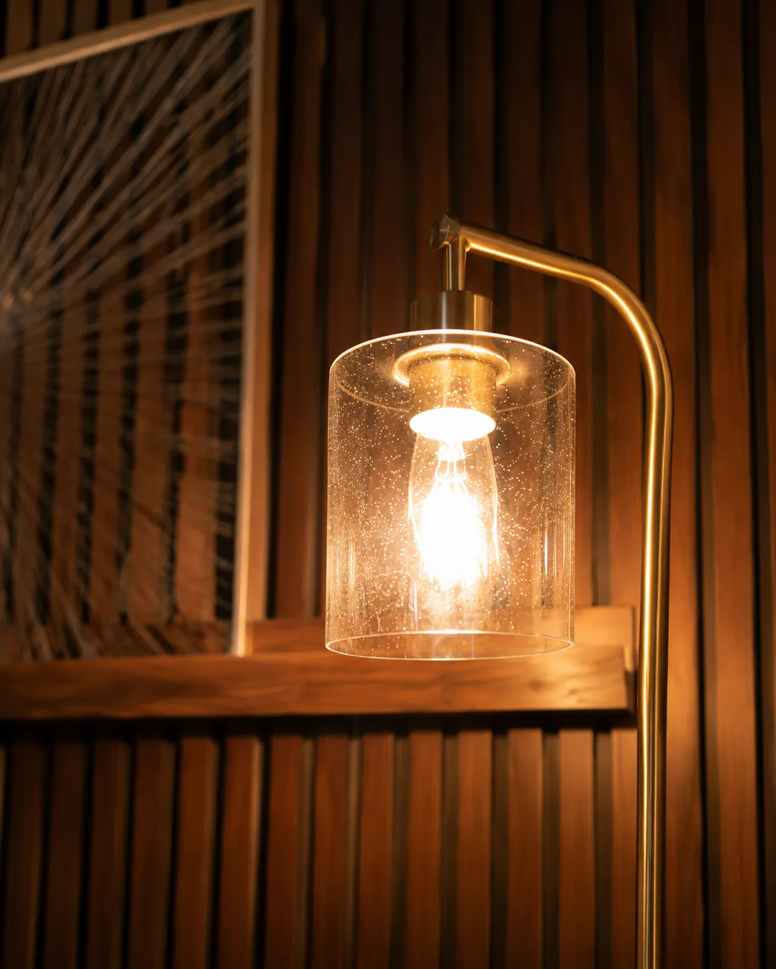 Warm lamp beside the wood-slat wall in the Despertares office