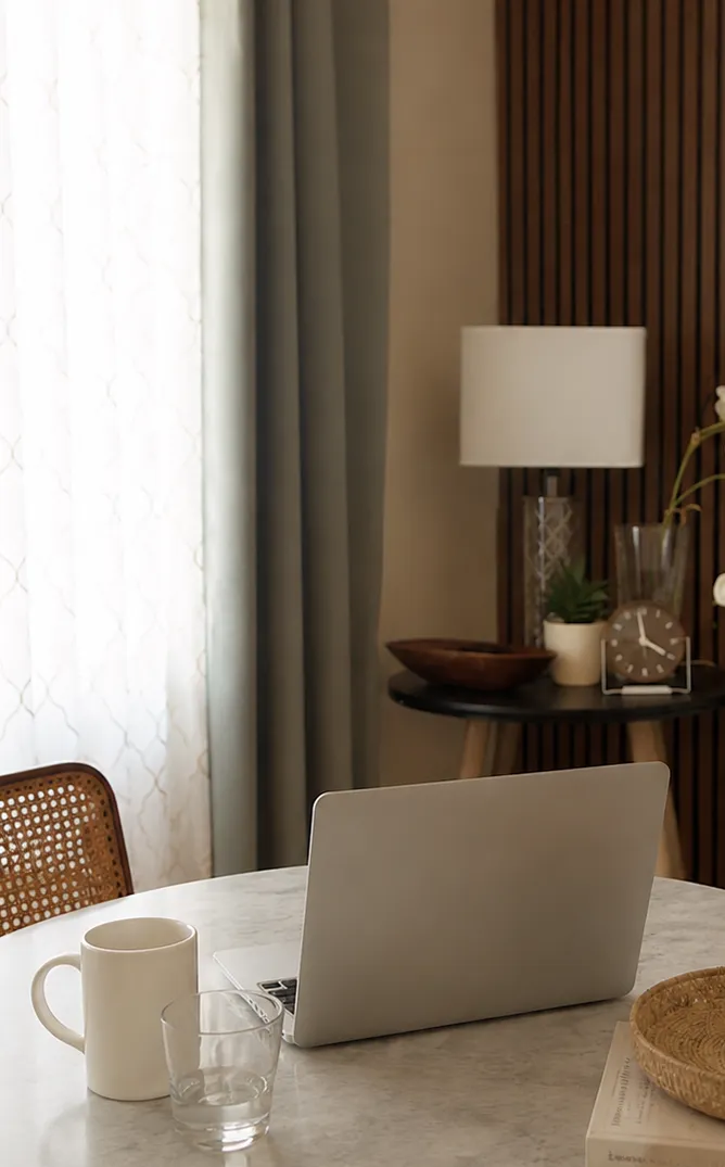 Desk with a laptop and coffee mug for virtual therapy sessions
