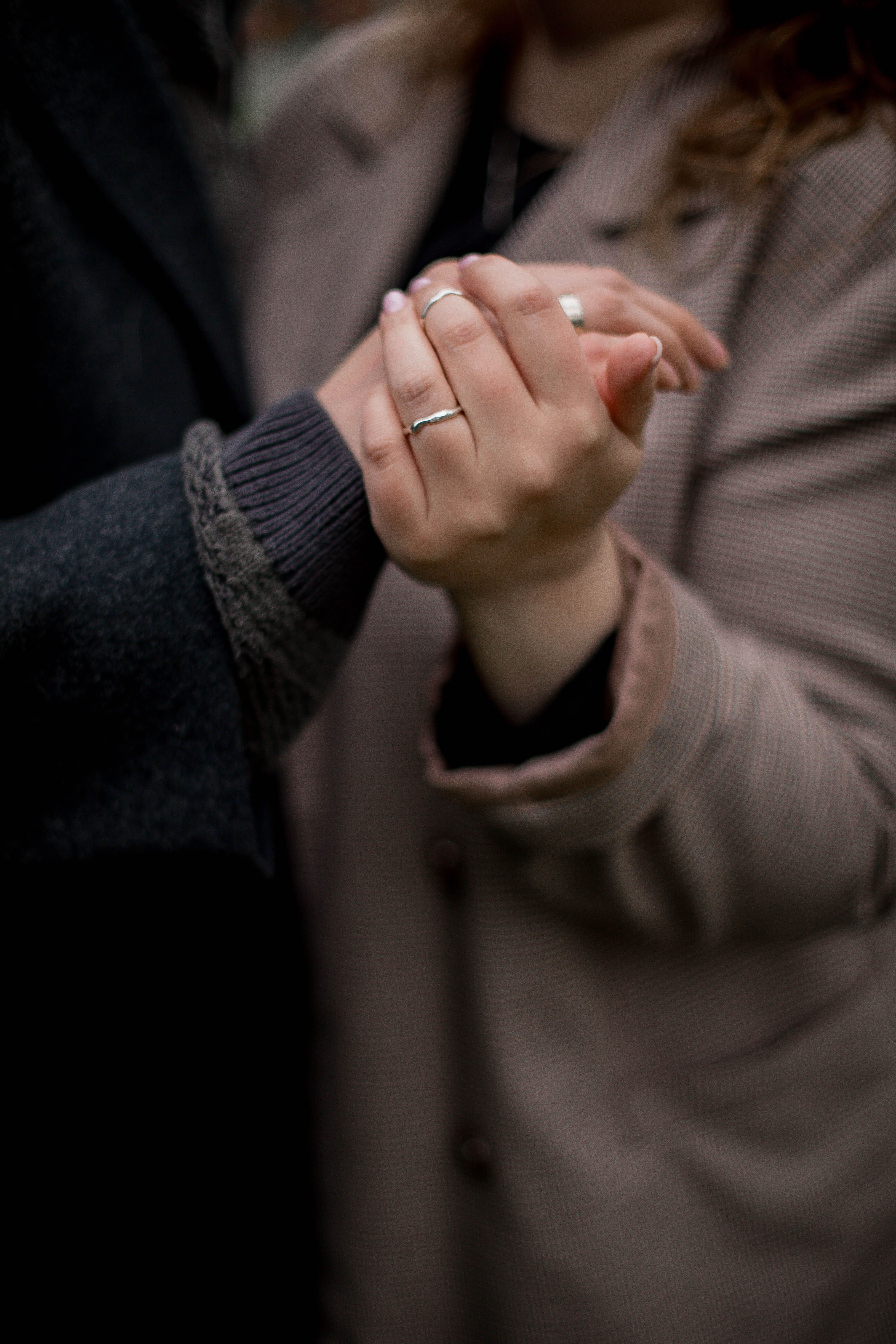 Couple holding hands in a gesture of connection and support